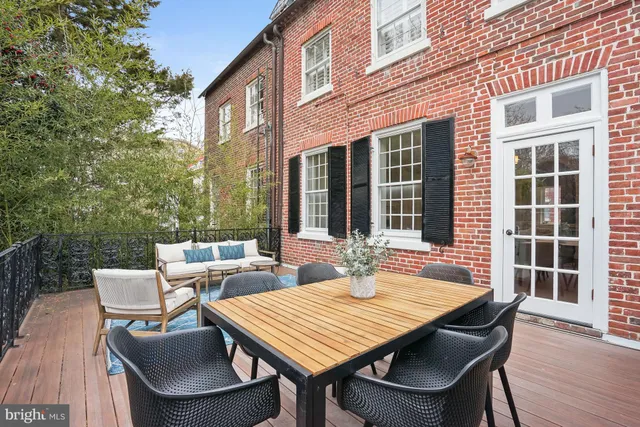 a view of a patio with a table and chairs