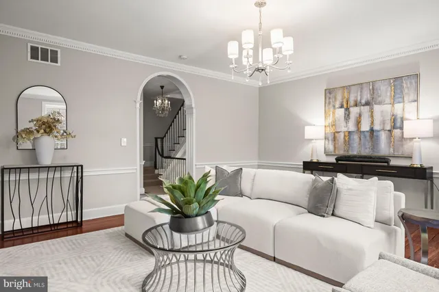 a living room with furniture and a chandelier