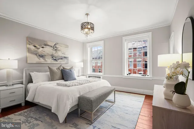 a bedroom with bed and wooden floor