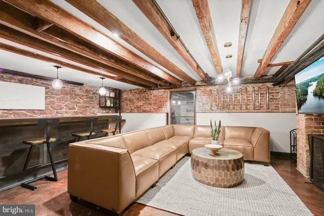 a living room with furniture and a chandelier