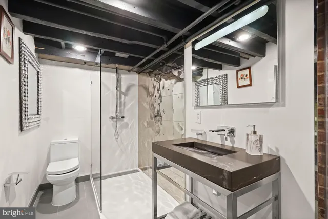 a bathroom with a sink toilet and shower