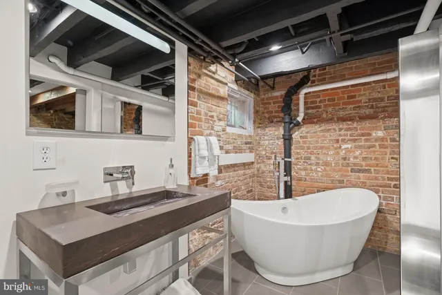 a bathroom with a bathtub and a sink