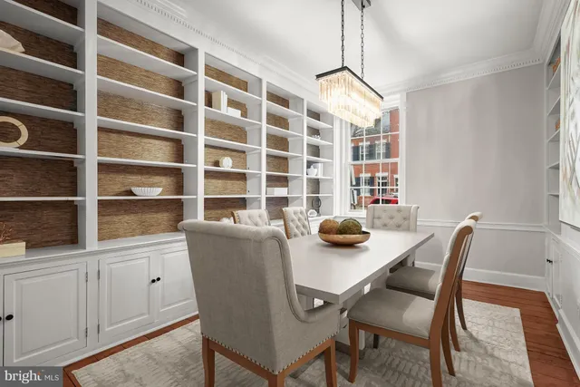 a view of a dining room that has a table and chairs in it