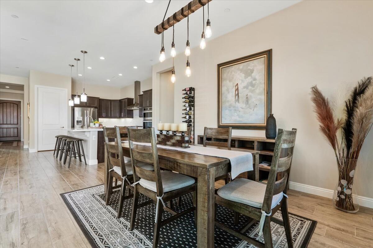 24 Claret Road Rancho Mirage, CA 92270 - Photo 11 of 34 a view of a dining room with furniture and wooden floor