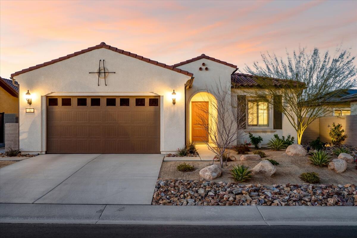 24 Claret Road Rancho Mirage, CA 92270 - Photo 2 of 34 a front view of a house with a yard