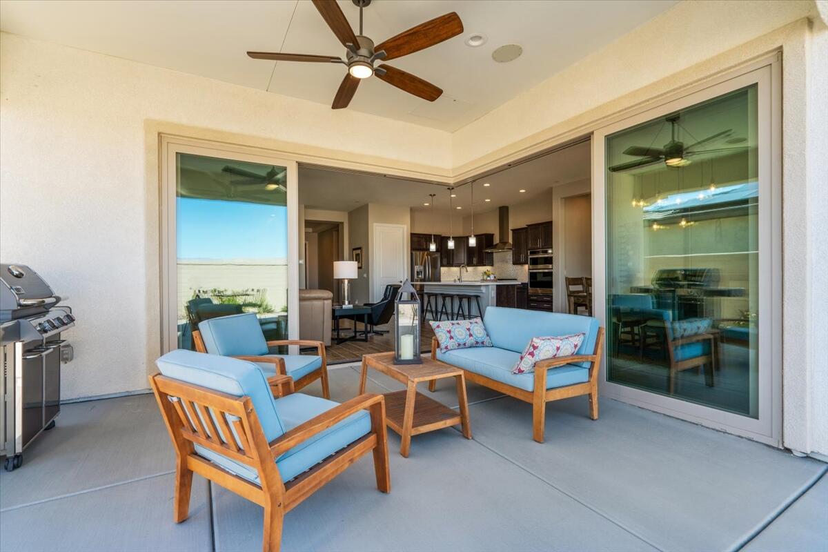 24 Claret Road Rancho Mirage, CA 92270 - Photo 21 of 34 a living room with furniture a ceiling fan and a rug