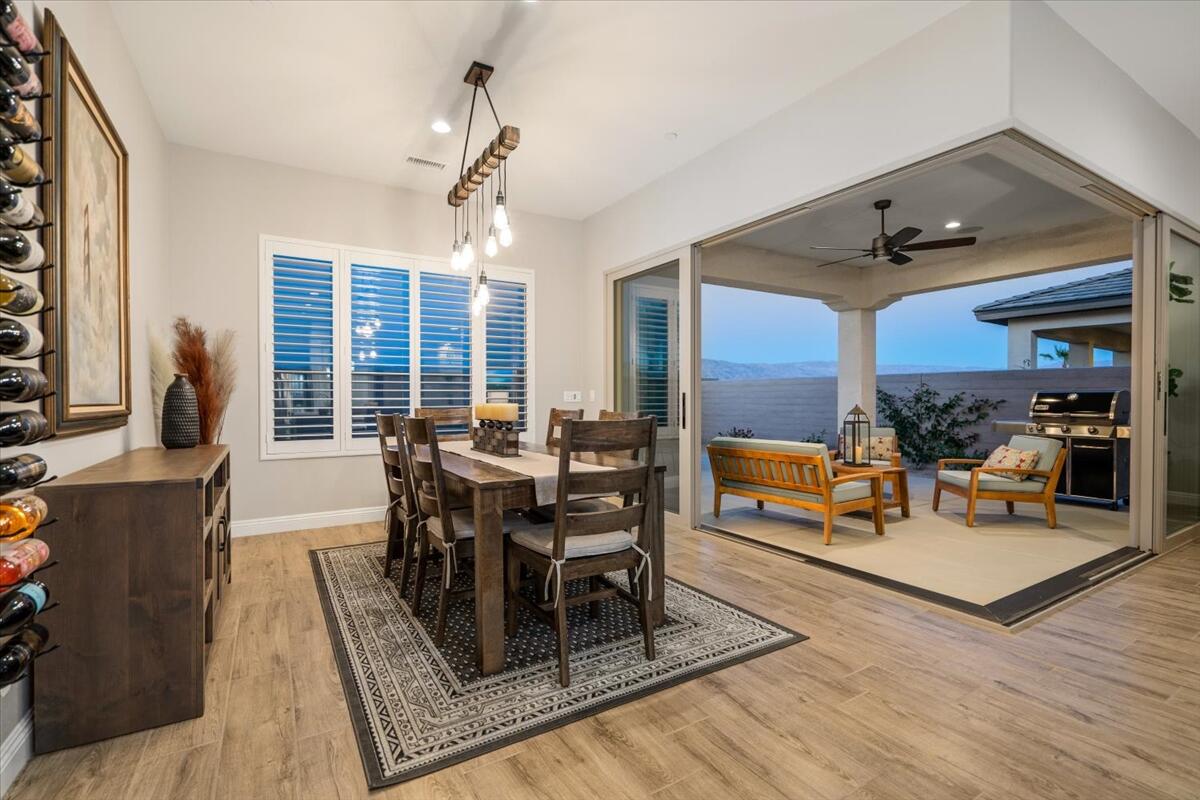 24 Claret Road Rancho Mirage, CA 92270 - Photo 27 of 34 a view of a dining room with furniture window and wooden floor