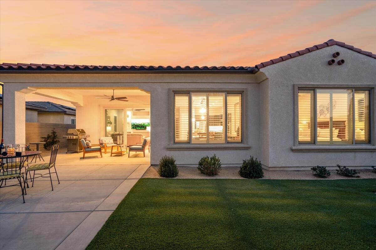 24 Claret Road Rancho Mirage, CA 92270 - Photo 30 of 34 a swimming pool with outdoor seating and a garden