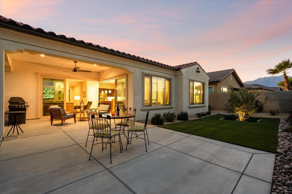 24 Claret Road Rancho Mirage, CA 92270 - Photo 32 of 34 a view of a patio with dining table and chairs with wooden fence