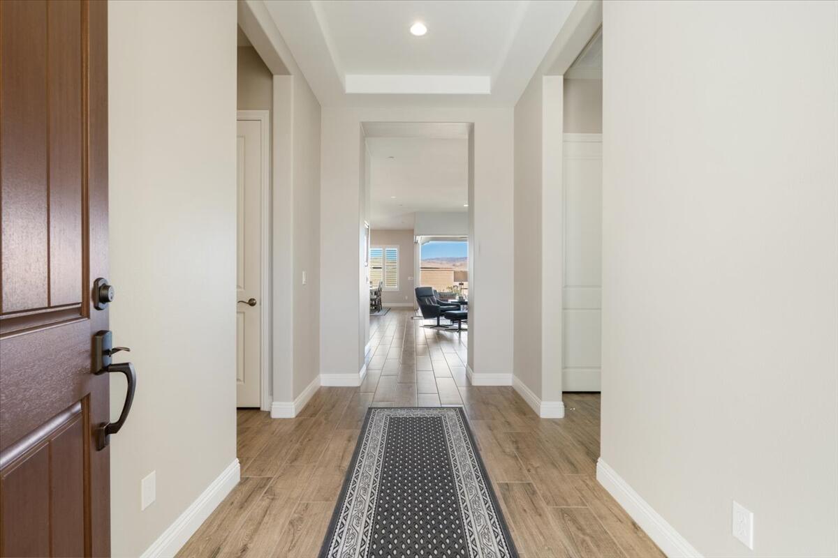 24 Claret Road Rancho Mirage, CA 92270 - Photo 4 of 34 a view of a hallway with wooden floor and furniture