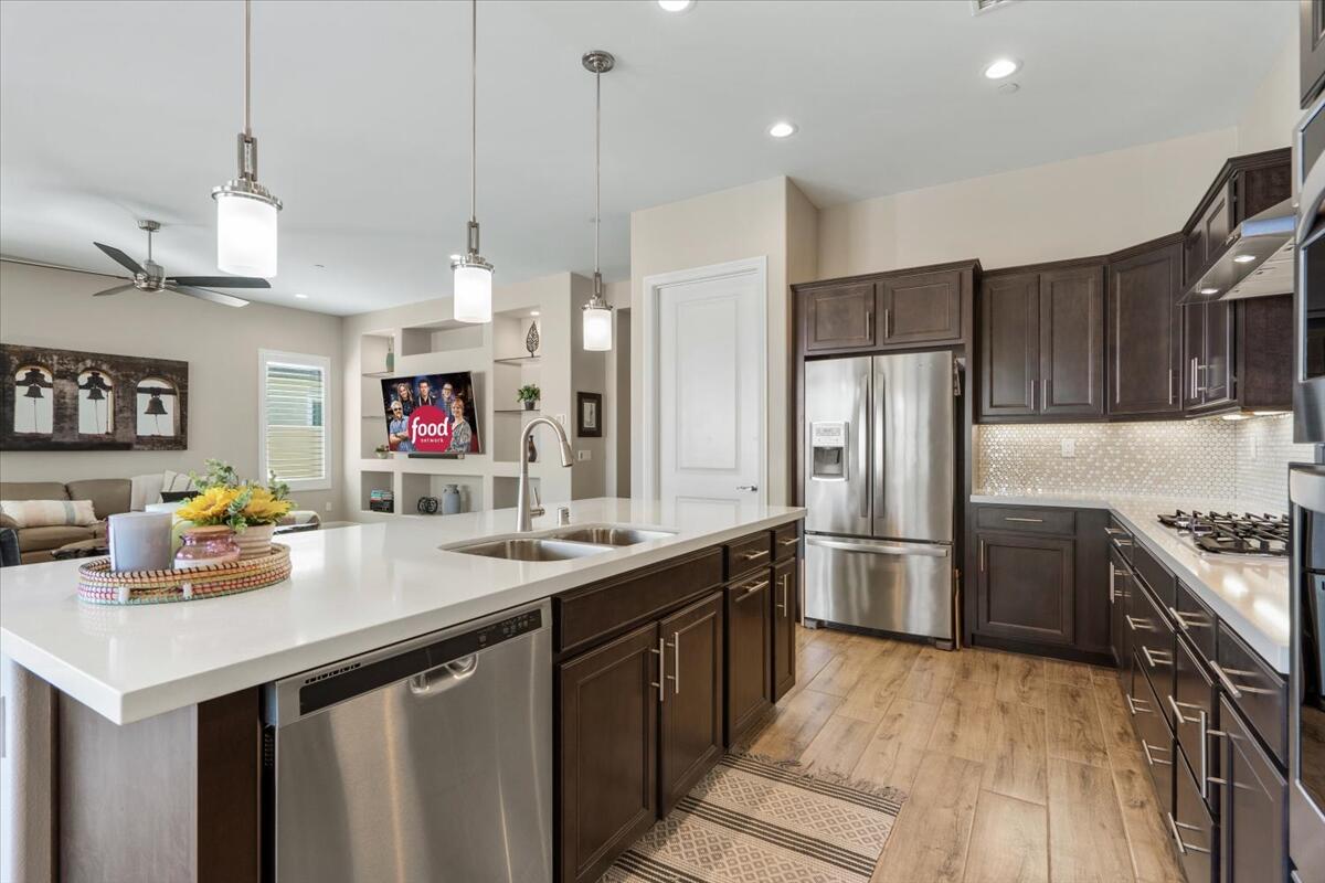 24 Claret Road Rancho Mirage, CA 92270 - Photo 9 of 34 a kitchen with stainless steel appliances granite countertop a sink a stove and a refrigerator