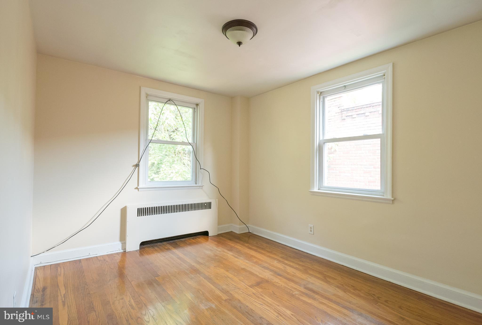 58 Burkleigh Road Baltimore, MD 21286 - Photo 12 of 23 an empty room with wooden floor and windows