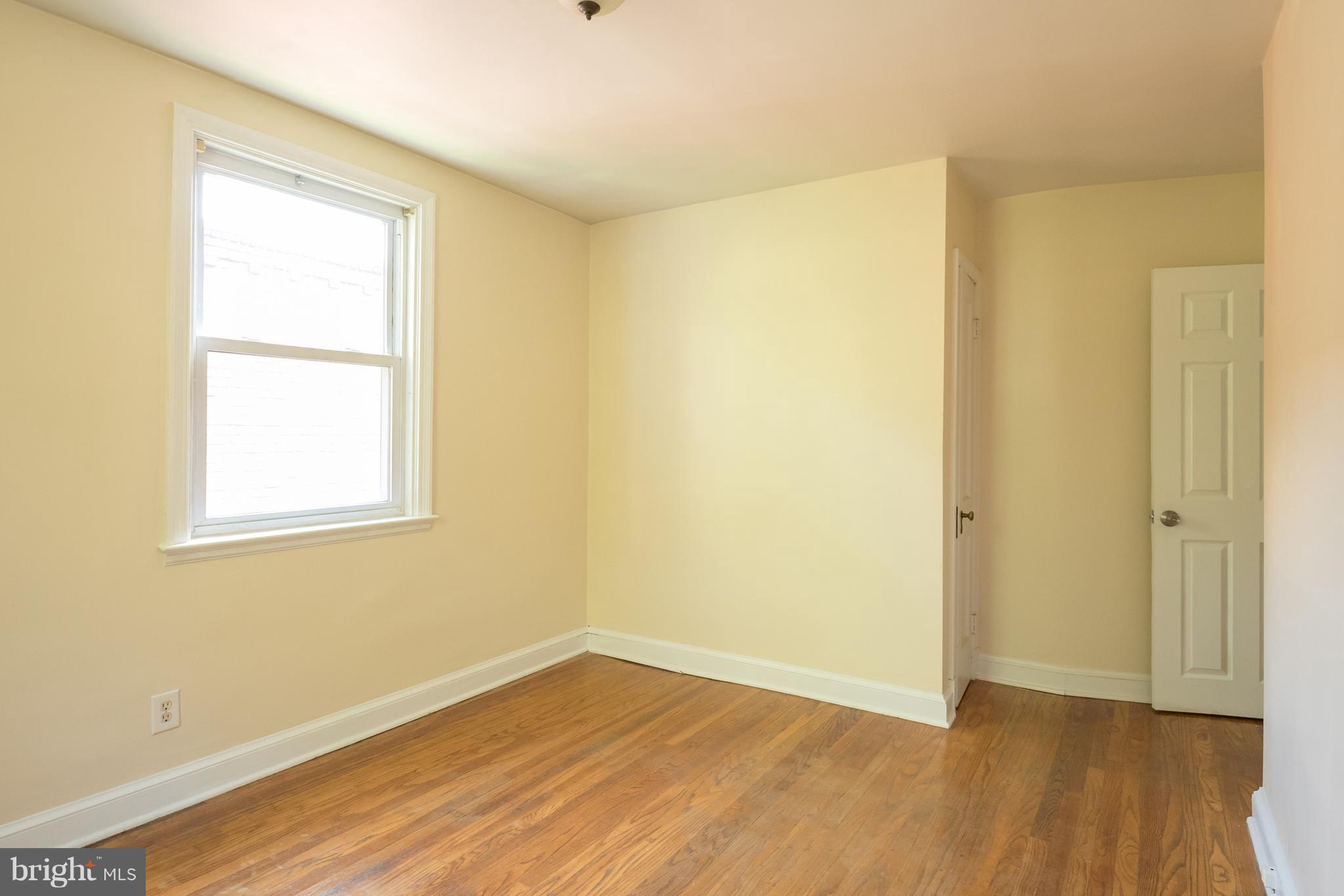 58 Burkleigh Road Baltimore, MD 21286 - Photo 13 of 23 a view of an empty room with wooden floor and a window