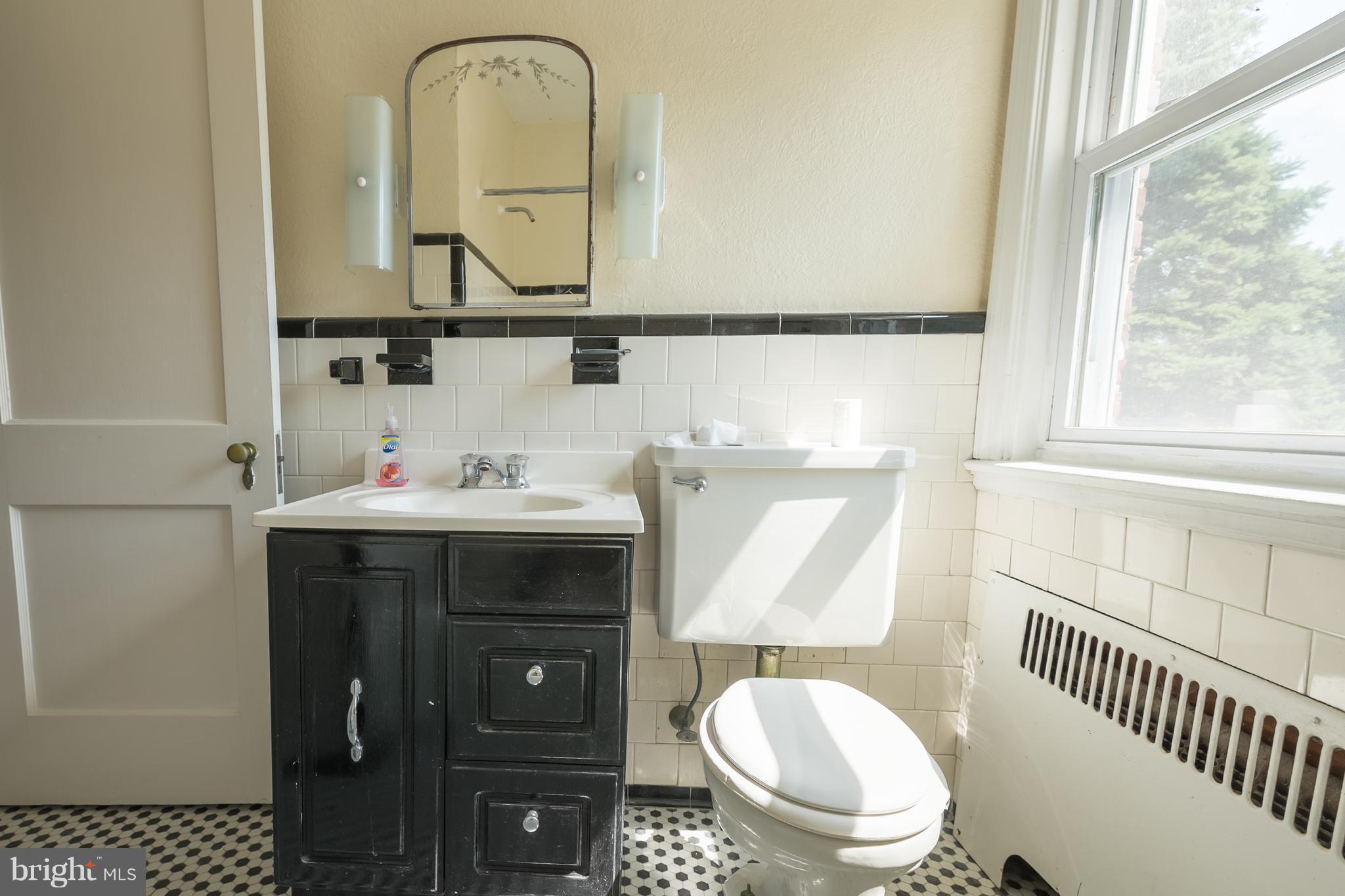 58 Burkleigh Road Baltimore, MD 21286 - Photo 15 of 23 a bathroom with a toilet a sink and mirror