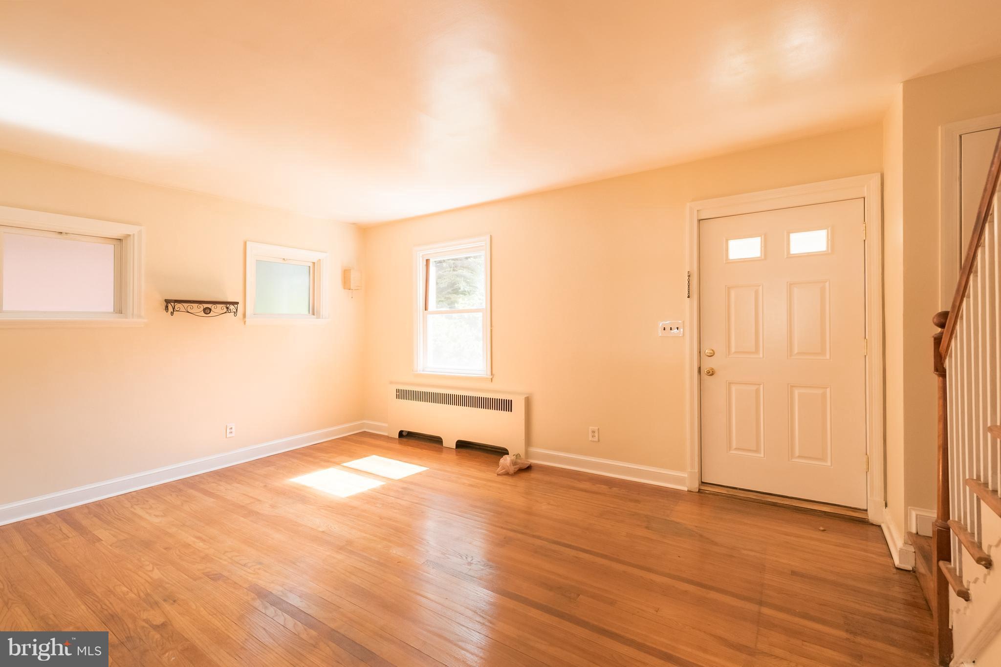 58 Burkleigh Road Baltimore, MD 21286 - Photo 3 of 23 a view of an empty room with wooden floor and a window
