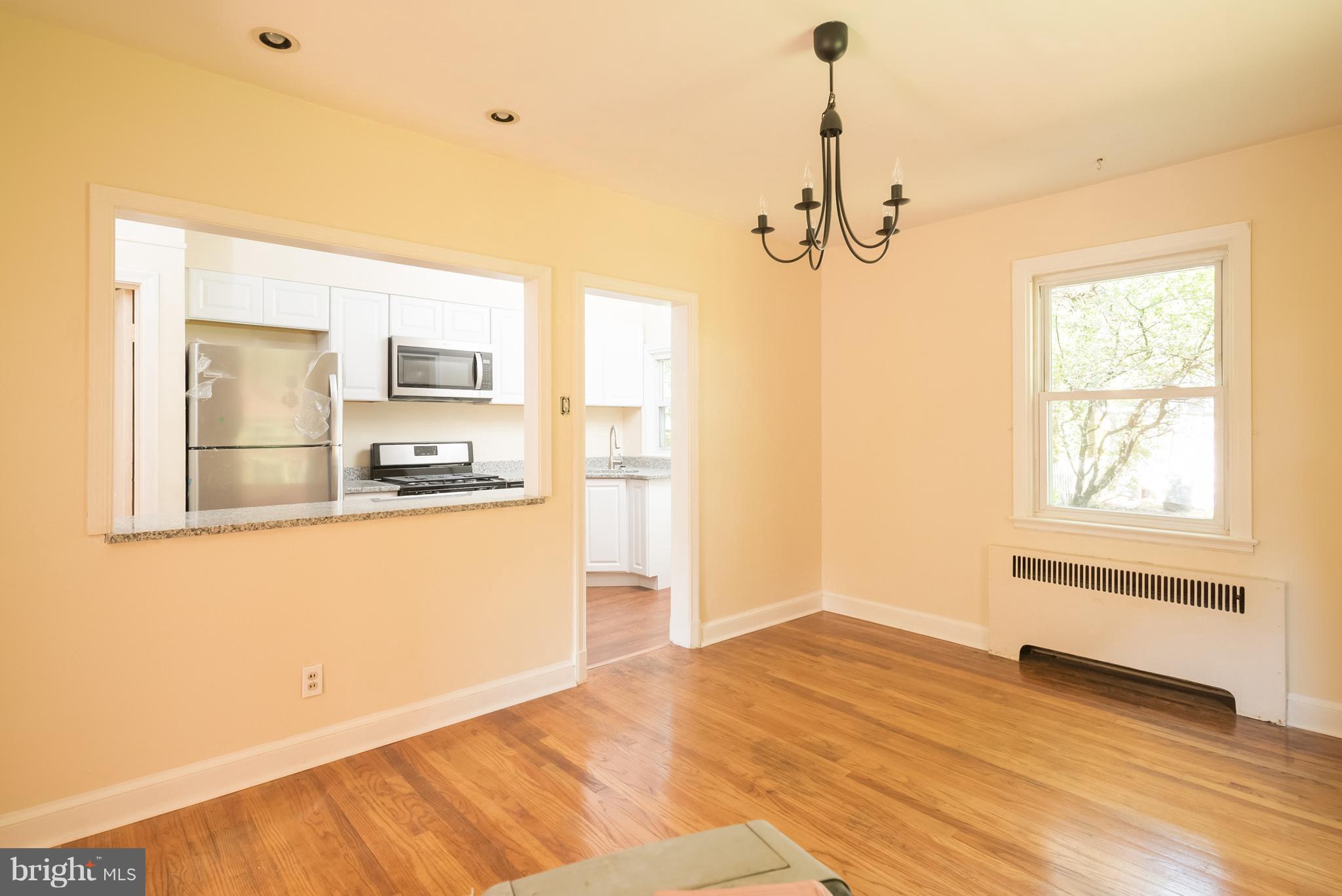 58 Burkleigh Road Baltimore, MD 21286 - Photo 4 of 23 a view of a kitchen with wooden floor electronic appliances and window