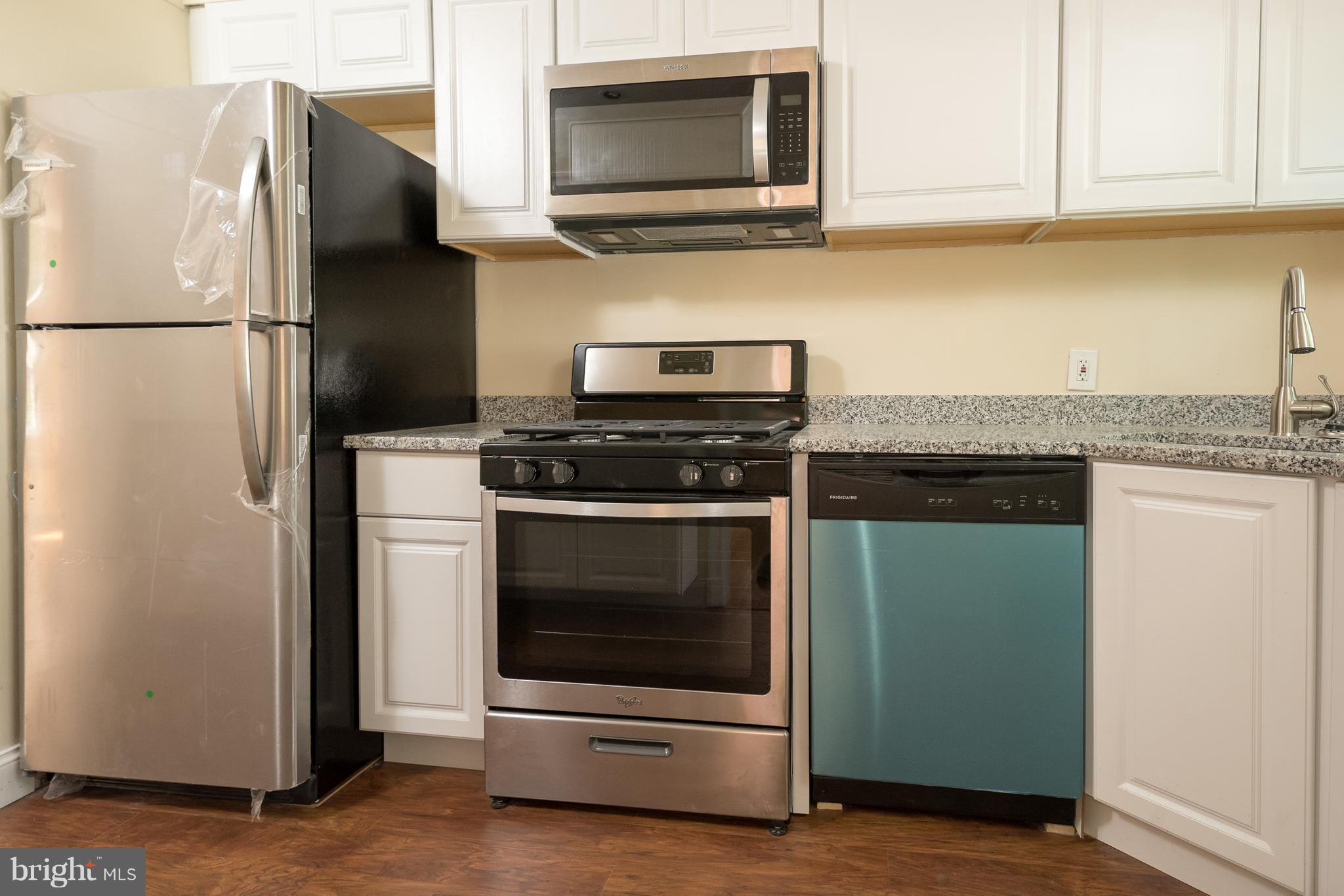 58 Burkleigh Road Baltimore, MD 21286 - Photo 5 of 23 a kitchen with stainless steel appliances granite countertop a refrigerator stove and microwave