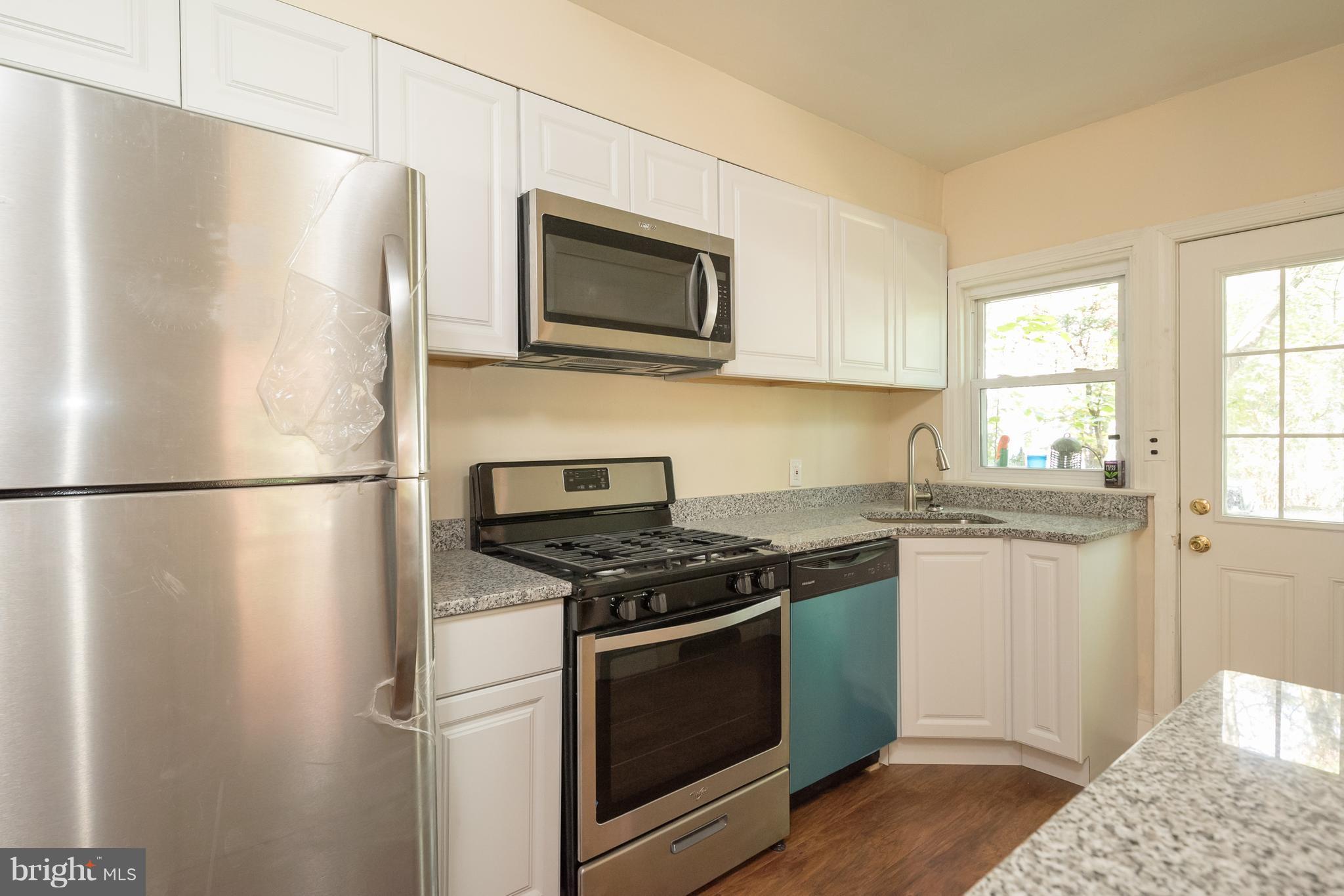 58 Burkleigh Road Baltimore, MD 21286 - Photo 6 of 23 a kitchen with stainless steel appliances granite countertop a refrigerator stove a sink and a microwave