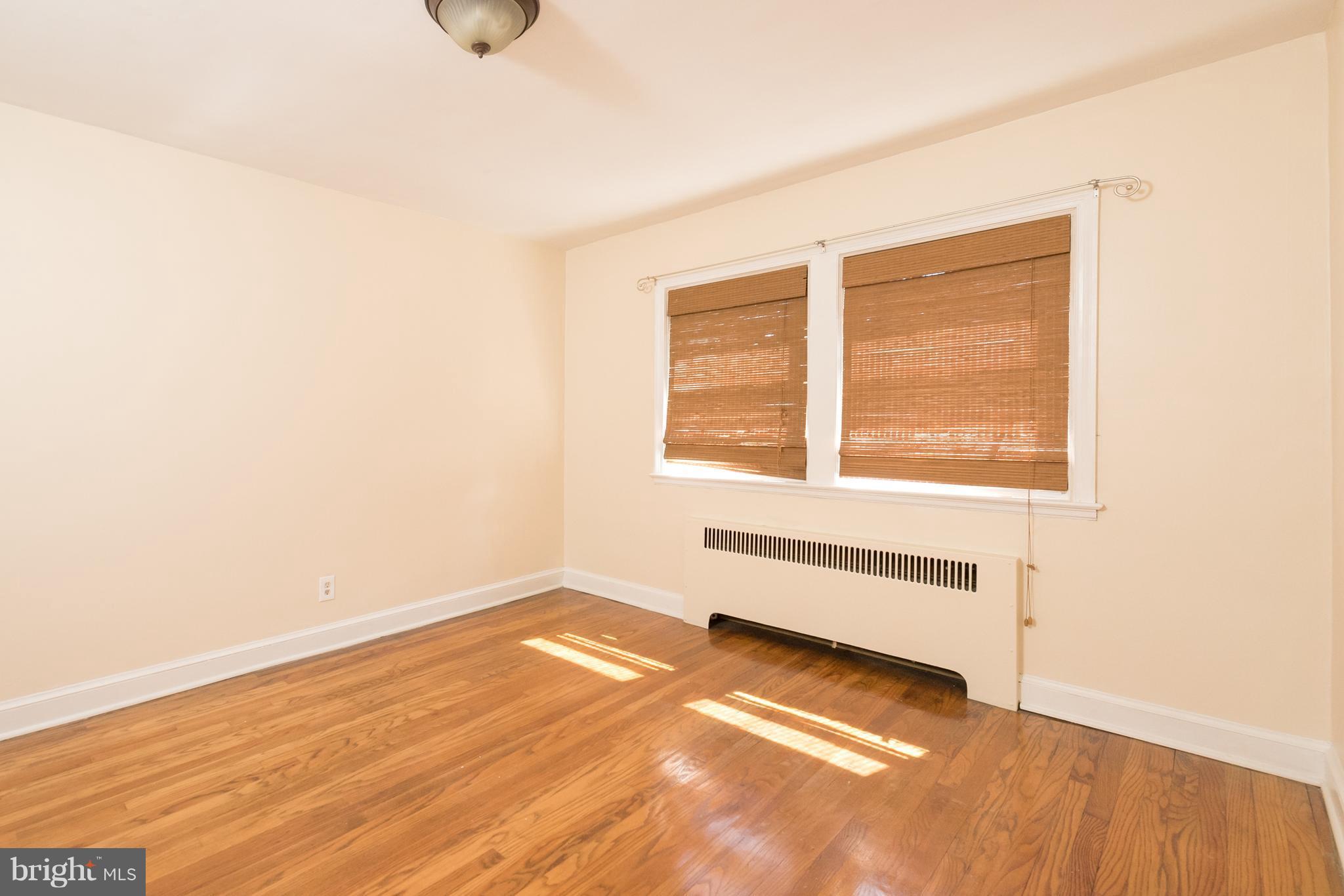 58 Burkleigh Road Baltimore, MD 21286 - Photo 7 of 23 a view of an empty room with wooden floor and a window