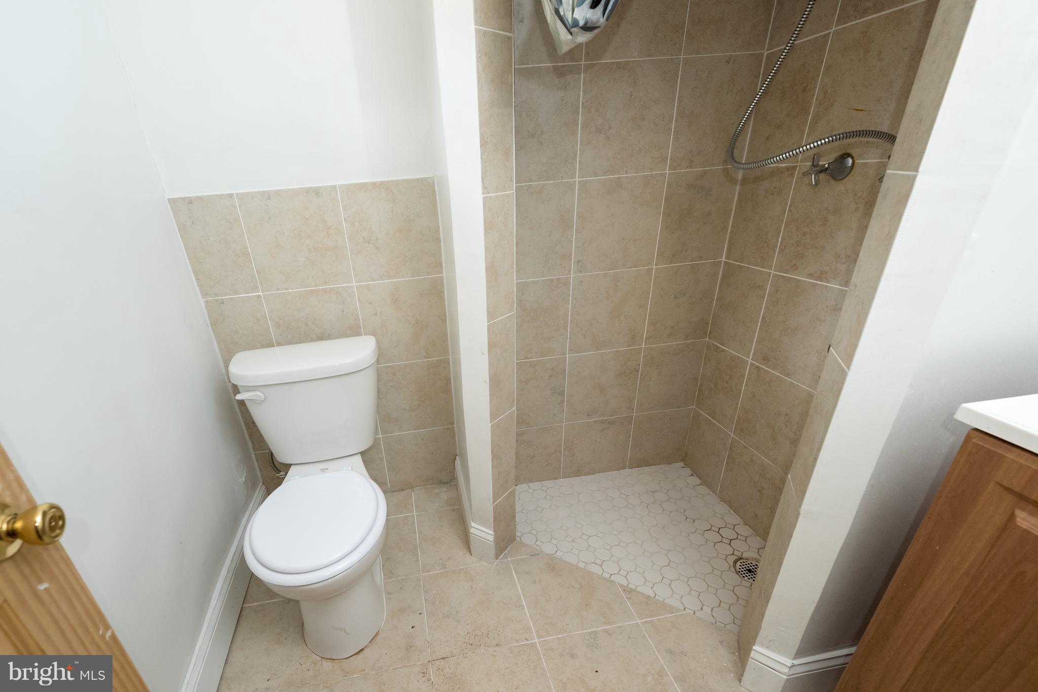 58 Burkleigh Road Baltimore, MD 21286 - Photo 9 of 23 a white toilet sitting next to a shower