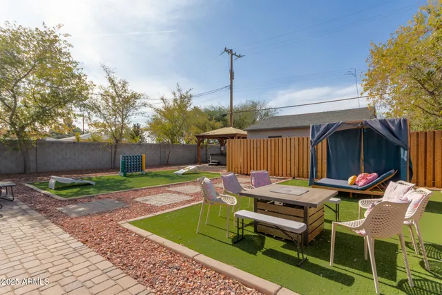 a table and chairs in patio of the house