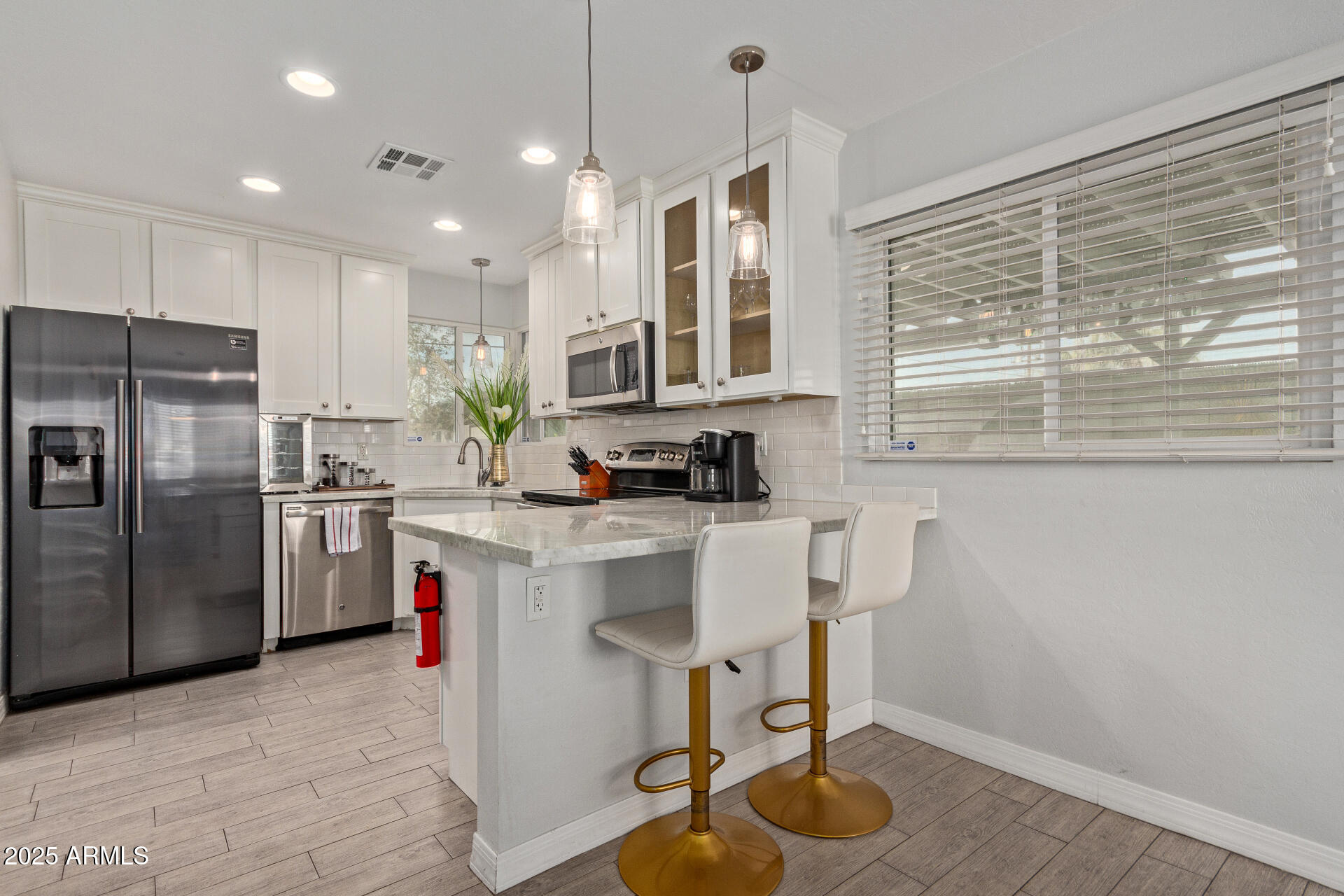 3132 North 15th Avenue Phoenix, AZ 85015 - Photo 11 of 28 a kitchen with a sink cabinets and stainless steel appliances