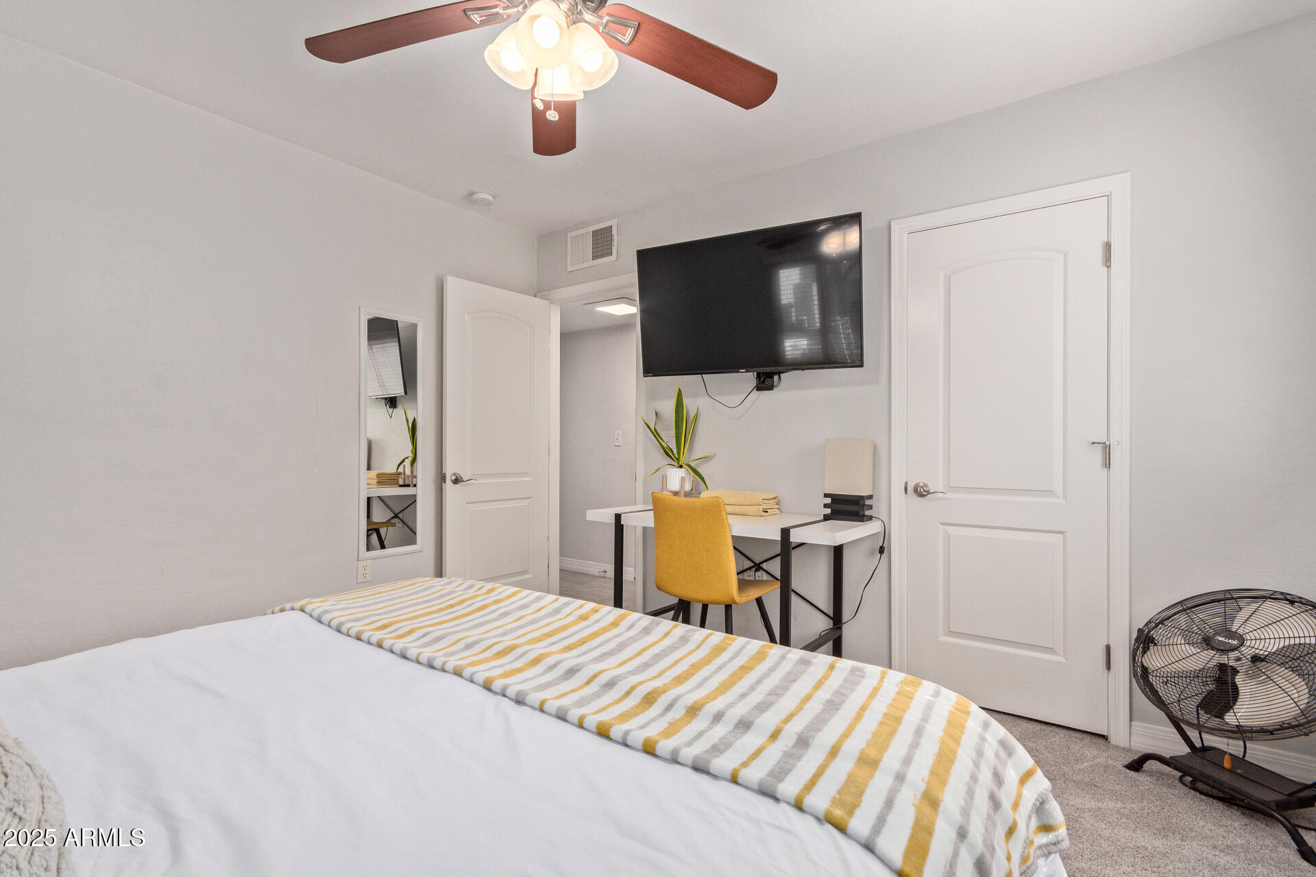 3132 North 15th Avenue Phoenix, AZ 85015 - Photo 19 of 28 a bedroom with a bed and a flat screen tv