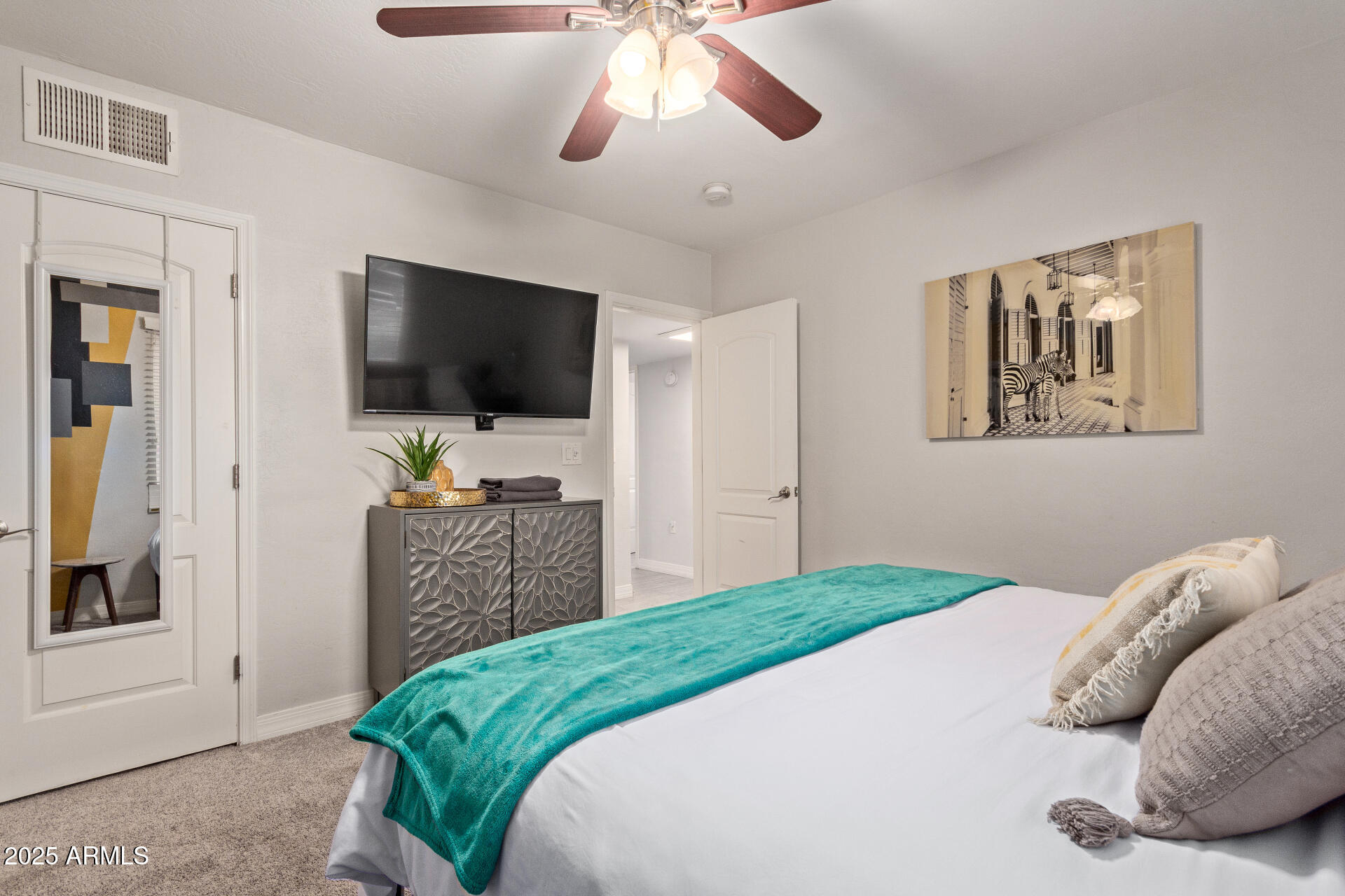 3132 North 15th Avenue Phoenix, AZ 85015 - Photo 21 of 28 a bedroom with a bed and a flat screen tv