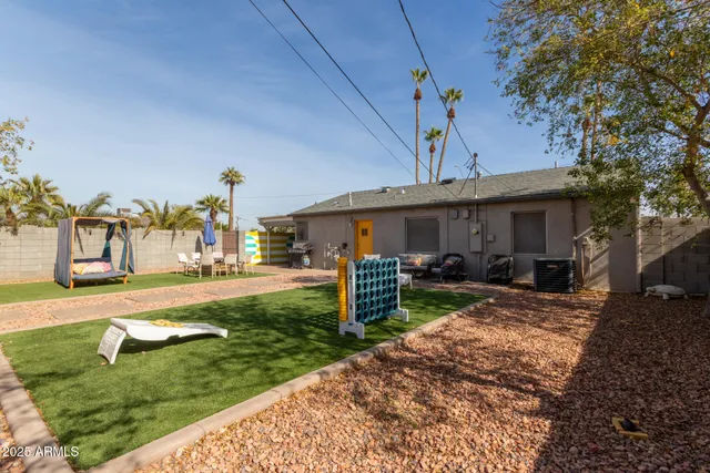 a view of a house with backyard and sitting area
