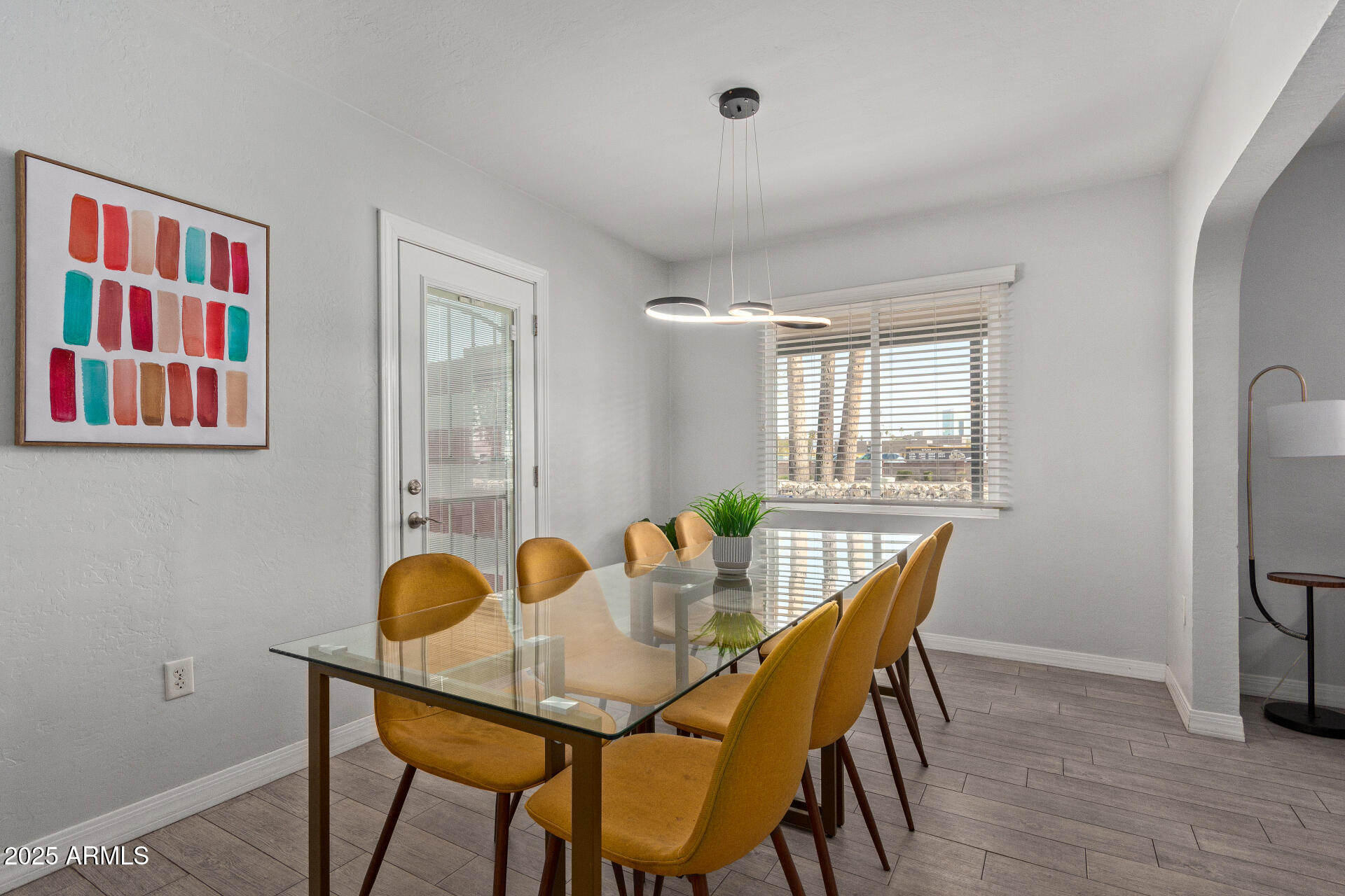 3132 North 15th Avenue Phoenix, AZ 85015 - Photo 10 of 28 a view of a dining room with furniture and wooden floor