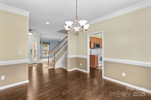 a view of a room with wooden floor and staircase