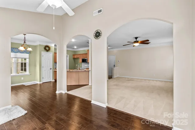 a view of a hallway with wooden floor and entryway