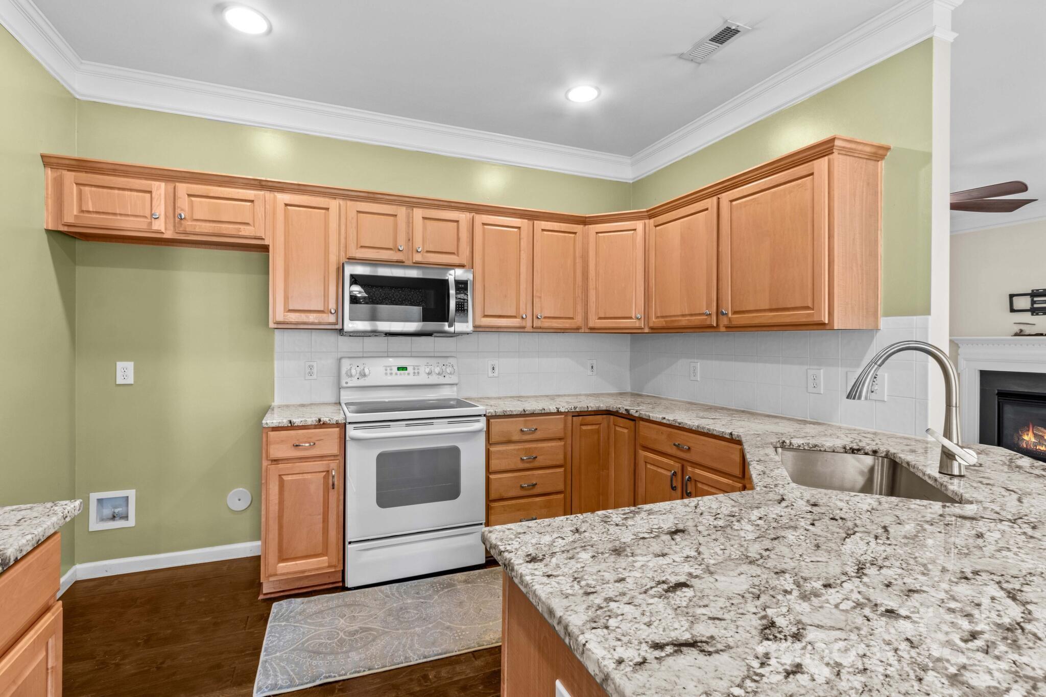 124 Elizabeth Hearth Road Mooresville, NC 28115 - Photo 23 of 48 a kitchen with stainless steel appliances granite countertop a stove top oven a sink and dishwasher