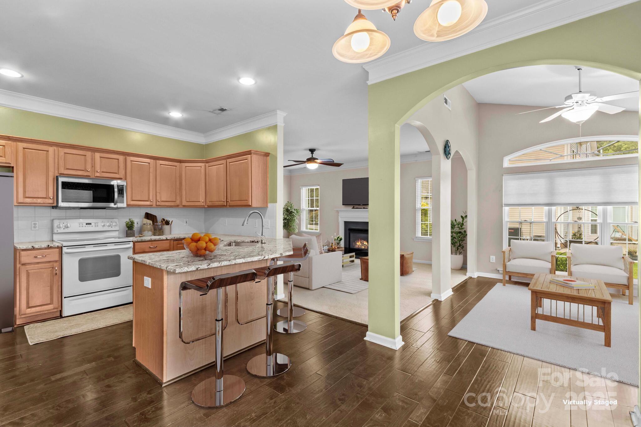 124 Elizabeth Hearth Road Mooresville, NC 28115 - Photo 27 of 48 a living room with stainless steel appliances granite countertop furniture wooden floor and a view of kitchen