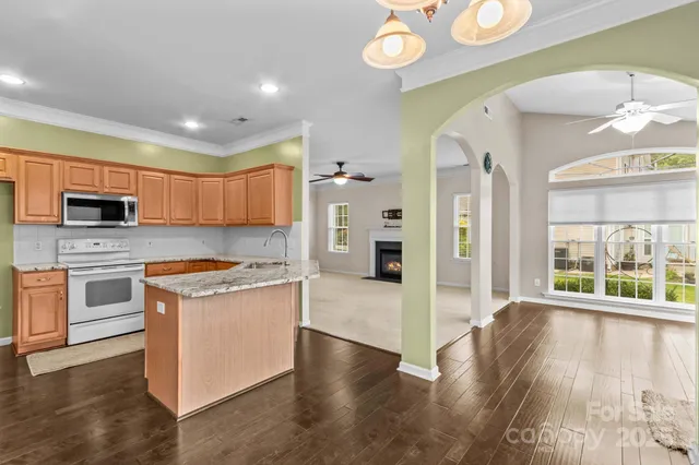 a kitchen with stainless steel appliances granite countertop a stove and a refrigerator