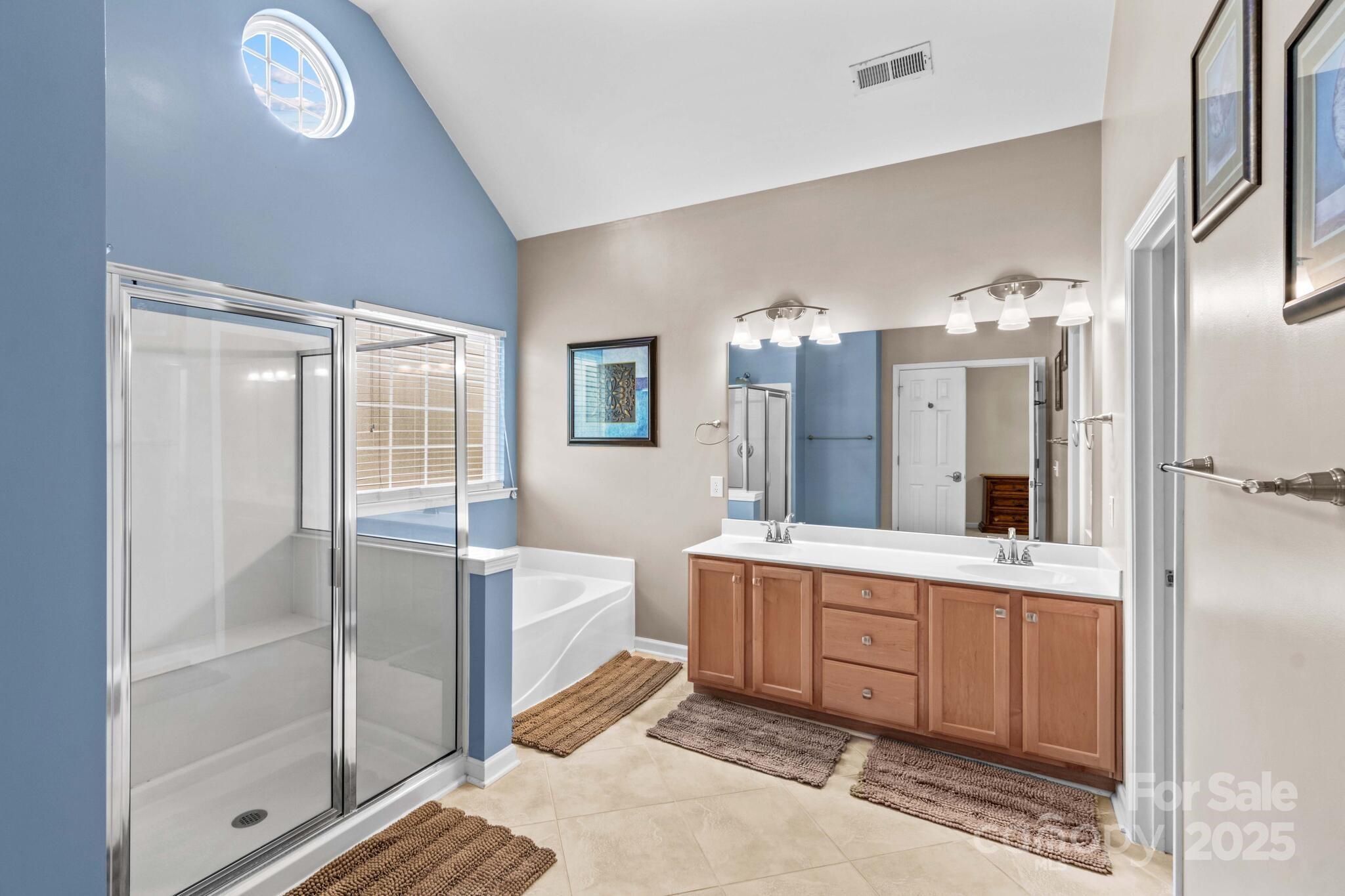 124 Elizabeth Hearth Road Mooresville, NC 28115 - Photo 31 of 48 a spacious bathroom with a double vanity sink a mirror and a shower