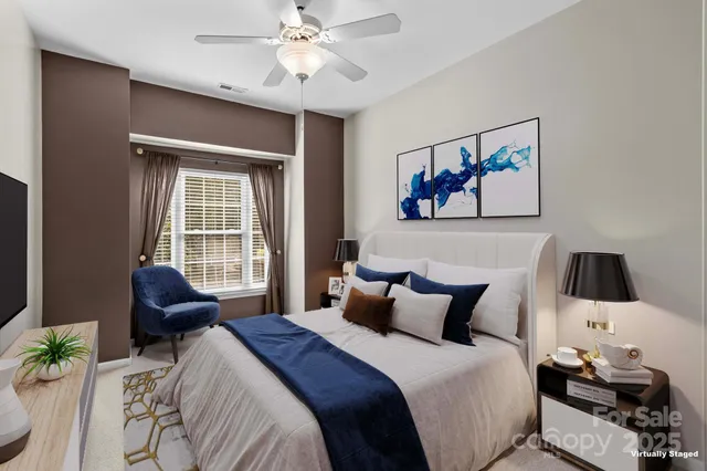 a bedroom with a bed and a painting on the wall