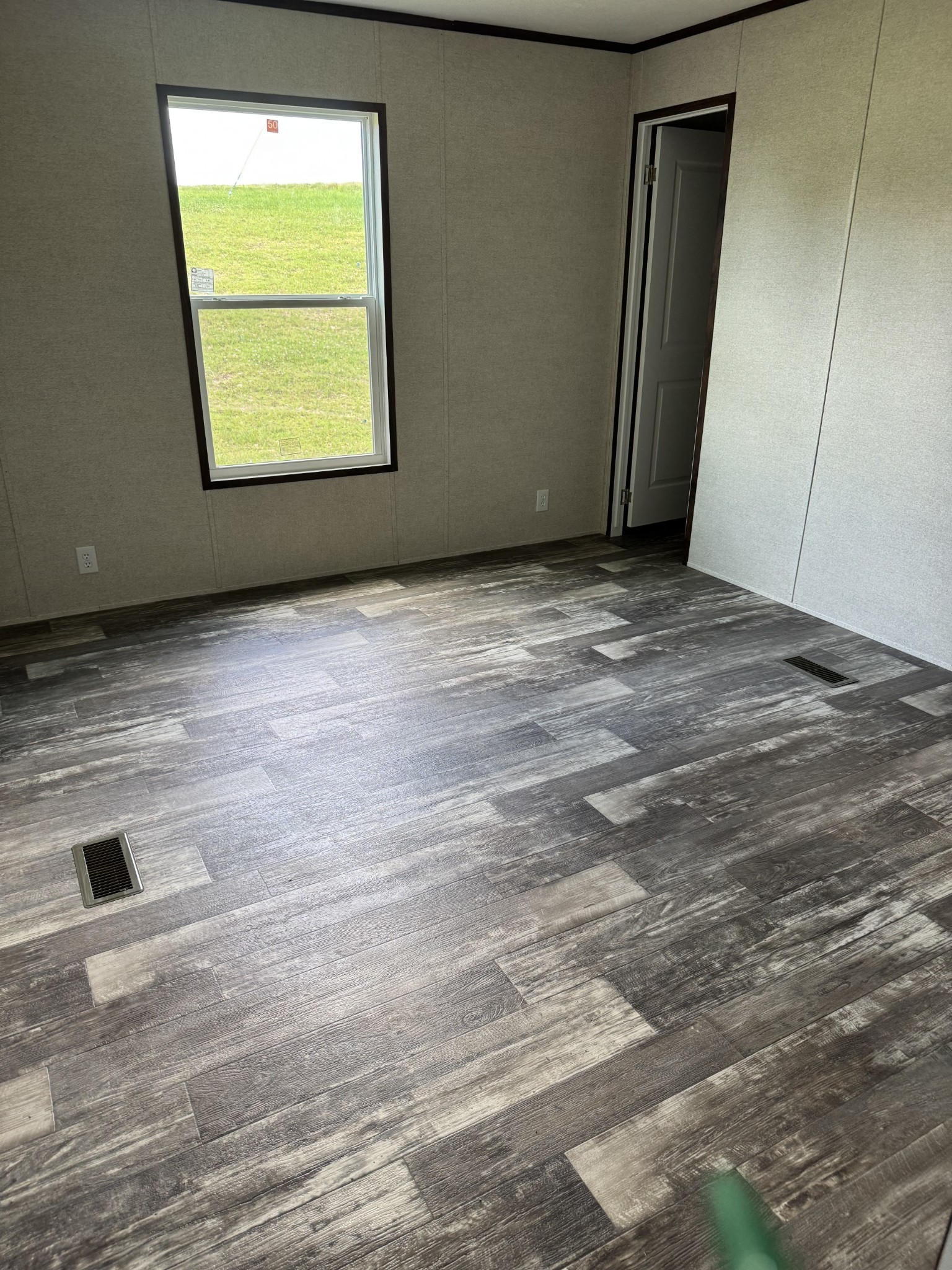 9494 Sunrise Road Red Boiling Springs, TN 37150 - Photo 8 of 10 a view of an empty room with wooden floor and a window