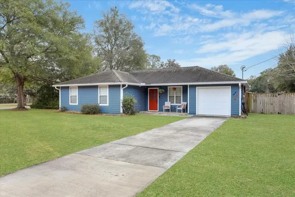 a front view of a house with a garden