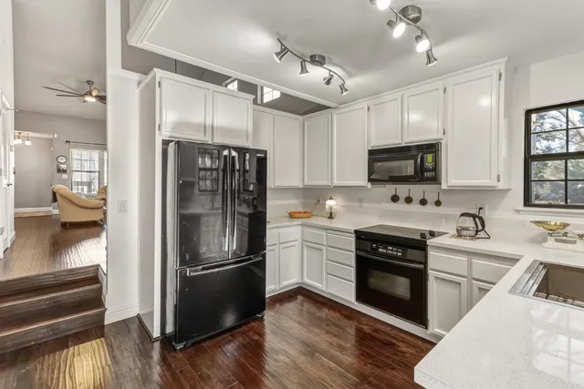 a kitchen with a refrigerator stove and sink