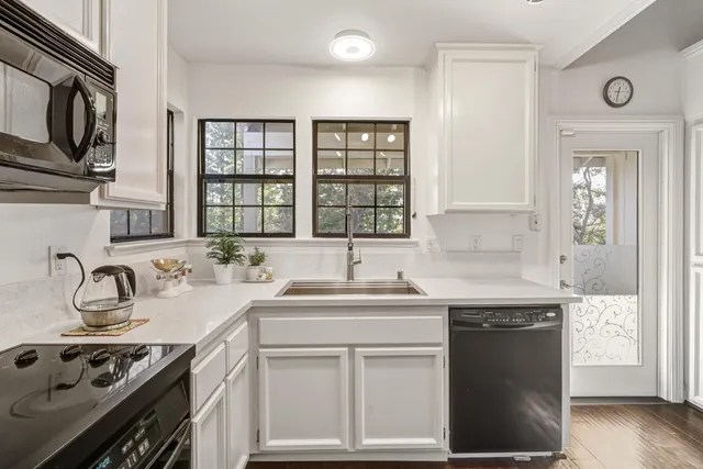 a kitchen with a sink stove and cabinets