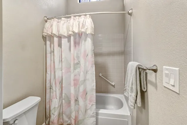 a bathroom with a shower and a toilet