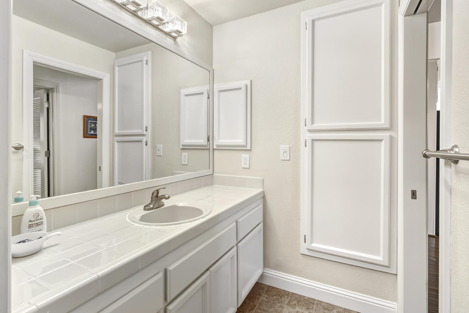 3901 Park Cir Lane, Unit B Carmichael, CA 95608 - Photo 28 of 40 a bathroom with a sink vanity granite and a mirror