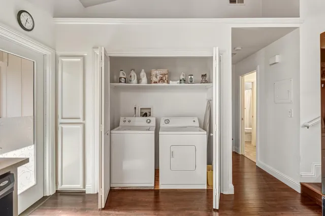 a view of washer and dryer with wooden floor