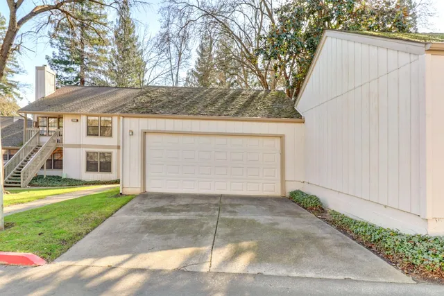 a view of a house with a yard and garage