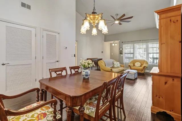 a view of a dining room with furniture and chandelier
