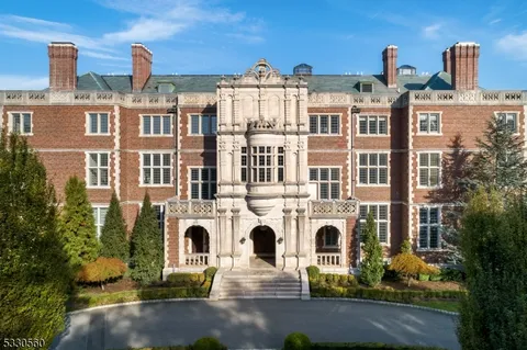 a front view of a residential apartment building with a yard
