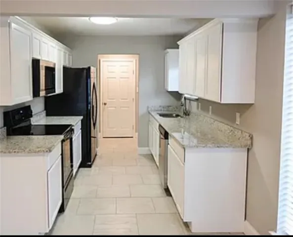 a kitchen with a sink stove and refrigerator