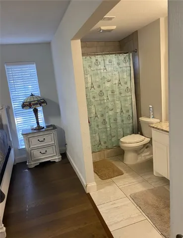 a bathroom with a toilet and a shower
