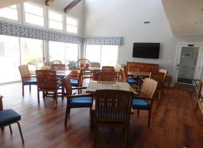 4396 Baldwin Avenue, Unit 82 Little River, SC 29566 - Photo 31 of 35 Dining room featuring a towering ceiling, dark wood-type flooring, and beam ceiling
